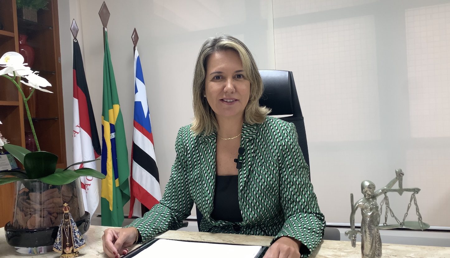 Foto da presidente do TRT-16, desembargadora Márcia Andrea Farias. Ao fundo as bandeiras do Brasil, do Maranhão e do TRT-16.