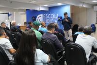 Foto de uma pessoa realizando uma palestra para outras pessoas.