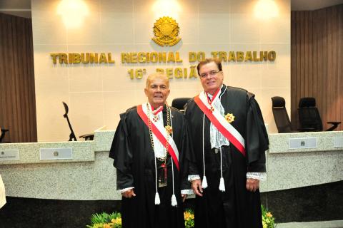 Dois homens de toga em pé, um ao lado do outro, pousando para foto